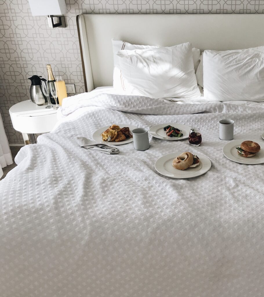 Hotel room with breakfast in bed - Arise hotel marketing