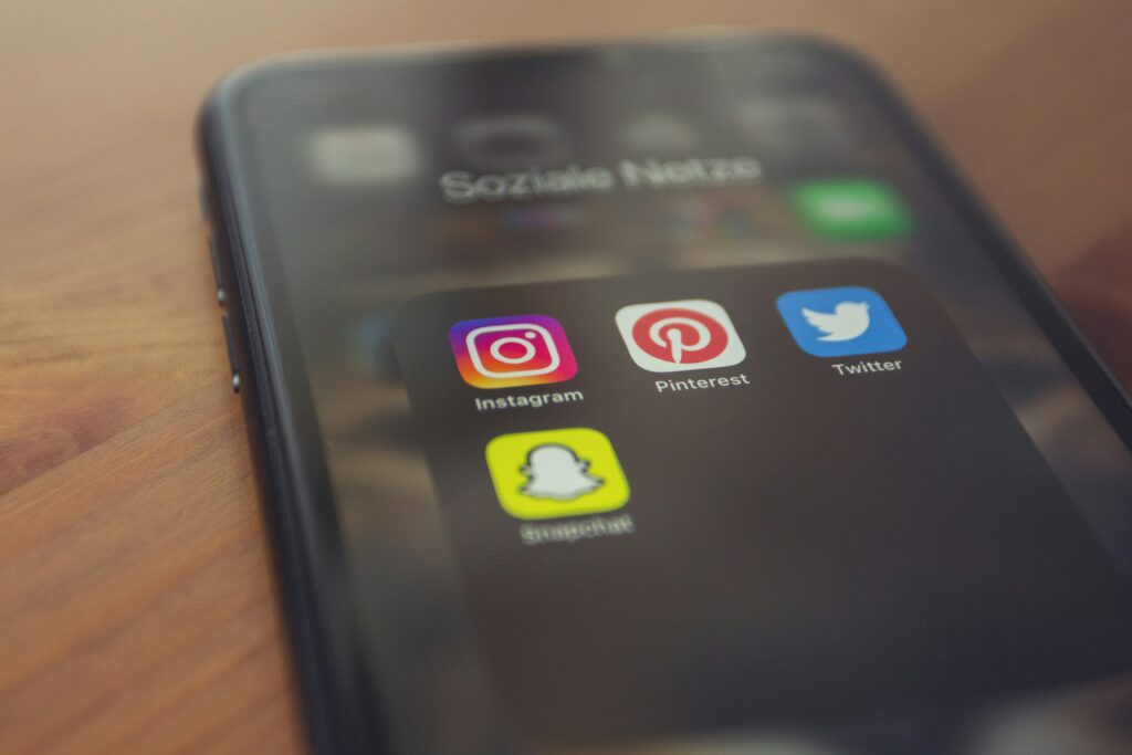 phone with social media widgets on the screen - Arise Hotel Marketing